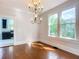 Elegant dining room with hardwood floors, chandelier, and view to kitchen at 345 N Clara Ave, Deland, FL 32720
