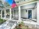 Large front porch with white columns and American flag at 345 N Clara Ave, Deland, FL 32720