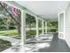Spacious front porch with white columns and view of street at 345 N Clara Ave, Deland, FL 32720