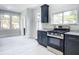 Modern kitchen features stainless steel appliances and dark cabinetry at 345 N Clara Ave, Deland, FL 32720