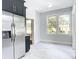 Stainless steel refrigerator in updated kitchen with light gray floors at 345 N Clara Ave, Deland, FL 32720