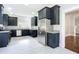 Modern kitchen with dark cabinets, stainless steel appliances, and granite countertops at 345 N Clara Ave, Deland, FL 32720