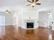 Living room with hardwood floors, fireplace, and access to staircase at 345 N Clara Ave, Deland, FL 32720