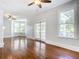 Spacious living room featuring hardwood floors, high ceilings, and large windows at 345 N Clara Ave, Deland, FL 32720