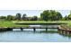 Serene golf course with a wooden bridge over water at 3558 Nw 56Th Ave, Ocala, FL 34482