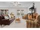 Spacious living room with leather sofa, armchairs, and large windows at 3558 Nw 56Th Ave, Ocala, FL 34482