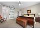 Main bedroom with a comfortable bed and sliding barn door to the bathroom at 3558 Nw 56Th Ave, Ocala, FL 34482