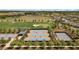 Aerial view of tennis courts, landscaping, and clubhouse at 3558 Nw 56Th Ave, Ocala, FL 34482