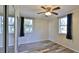 Bright bedroom with wood-look floors, ceiling fan, and mirrored closet doors at 365 Fletcher Ave, Daytona Beach, FL 32114