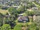 An aerial shot featuring a home surrounded by trees, situated close to a golf course at 376 Hampton Hills Ct, Debary, FL 32713