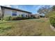 Spacious backyard with sloping lawn and partial view of a neighboring home at 376 Hampton Hills Ct, Debary, FL 32713