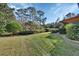 Spacious backyard featuring well-manicured lawn and hedgerows at 376 Hampton Hills Ct, Debary, FL 32713