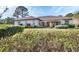 Landscaped backyard with lush greenery and a partially covered patio at 376 Hampton Hills Ct, Debary, FL 32713