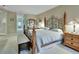 Bright bedroom with a king-size bed and an ornate headboard at 376 Hampton Hills Ct, Debary, FL 32713