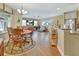 Bright dining room featuring a wooden table with four chairs, hardwood floors, and a large window at 376 Hampton Hills Ct, Debary, FL 32713