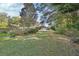 House exterior showcasing a driveway and tree-lined landscape at 376 Hampton Hills Ct, Debary, FL 32713