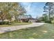 Single-story home with a large front yard, driveway, and mature trees at 376 Hampton Hills Ct, Debary, FL 32713