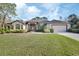 House exterior showcasing a manicured lawn and a two-car garage at 376 Hampton Hills Ct, Debary, FL 32713