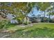 Landscaped front yard with lush lawn and mature trees at 376 Hampton Hills Ct, Debary, FL 32713