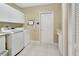 Functional laundry room with modern washer and dryer, white cabinets, and a convenient folding counter at 376 Hampton Hills Ct, Debary, FL 32713