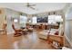 Spacious living room with hardwood floors, comfortable seating, and large TV at 376 Hampton Hills Ct, Debary, FL 32713