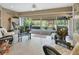 Relaxing sunroom with wicker furniture, providing plenty of natural light and backyard access at 376 Hampton Hills Ct, Debary, FL 32713