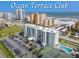 Ocean Terrace Club condo building aerial view, showing pool, tennis court, and parking at 3800 S Atlantic Ave # 4080, Daytona Beach, FL 32118