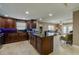 Spacious kitchen with dark wood cabinets, granite island, and stainless steel appliances at 404 S Beach St # 240 701, Daytona Beach, FL 32114