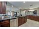 Modern kitchen featuring dark wood cabinets, granite counters and stainless steel appliances at 404 S Beach St # 240 701, Daytona Beach, FL 32114