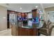 Modern kitchen with dark wood cabinets, granite countertop, and stainless steel appliances at 404 S Beach St # 240 701, Daytona Beach, FL 32114
