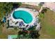 Kidney-shaped pool with lounge chairs and landscaping at 404 S Beach St # 240 701, Daytona Beach, FL 32114