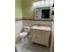 Bathroom with toilet, vanity, and decorative mirror at 444 S Deerwood Ave, Orlando, FL 32825