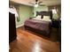 Spacious bedroom with hardwood floors and king-size bed at 444 S Deerwood Ave, Orlando, FL 32825