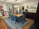 Spacious dining room with a large wooden table and blue chairs at 444 S Deerwood Ave, Orlando, FL 32825