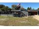 Gray brick ranch house with a 2-car garage and American flag at 444 S Deerwood Ave, Orlando, FL 32825