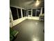 Enclosed Florida room with ample windows and gray floor at 444 S Deerwood Ave, Orlando, FL 32825