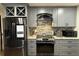 Modern kitchen with gray cabinets, granite countertops, and stainless steel appliances at 444 S Deerwood Ave, Orlando, FL 32825