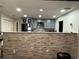 Kitchen with a stone wall breakfast bar and modern cabinets at 444 S Deerwood Ave, Orlando, FL 32825