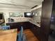 Kitchen with dark cabinets, granite counters, and a built-in bar at 444 S Deerwood Ave, Orlando, FL 32825