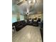 Living room with a large sectional sofa and wood-look tile floor at 444 S Deerwood Ave, Orlando, FL 32825