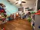 Playroom with hardwood floors and ample toy storage at 444 S Deerwood Ave, Orlando, FL 32825