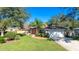 House exterior showcasing a two-car garage and well-manicured lawn at 446 N Pine Meadow Dr, Debary, FL 32713