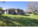 House with a large backyard, screened porch, and lake view at 524 Quail Hill Dr, Debary, FL 32713