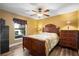 Bright bedroom with a queen-size bed and water view at 524 Quail Hill Dr, Debary, FL 32713