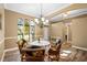 Elegant dining room with round table and wicker chairs at 524 Quail Hill Dr, Debary, FL 32713