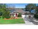 Beautiful lakefront home with a three-car garage and meticulously landscaped lawn at 524 Quail Hill Dr, Debary, FL 32713
