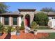 Home exterior featuring red door and landscaping at 524 Quail Hill Dr, Debary, FL 32713