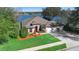 Lakefront home with red door and three-car garage at 524 Quail Hill Dr, Debary, FL 32713