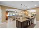 Open concept kitchen with island, granite countertops, and dark cabinets at 524 Quail Hill Dr, Debary, FL 32713