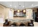 Granite kitchen island with dark wood cabinets and pendant lighting at 524 Quail Hill Dr, Debary, FL 32713